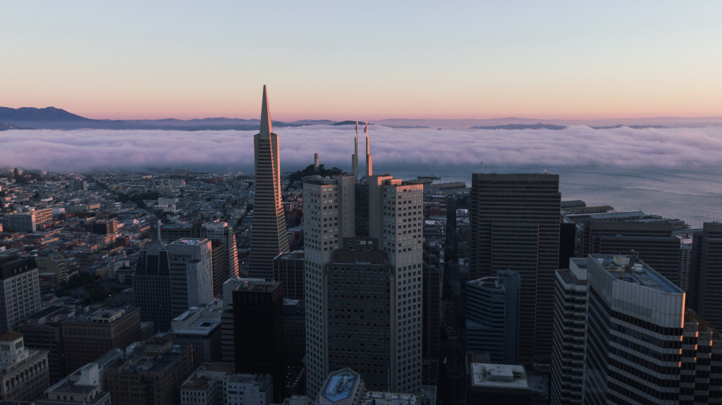 Aerial of San Francisco Skyline with pastel fog during sunset